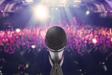 Microphone with an audience on the background